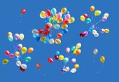 stock photo of blue sky  - Many color balloons isolated on blue sky - JPG 