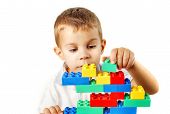 foto of embed  - Portrait of a child playing with plastic bricks - JPG 