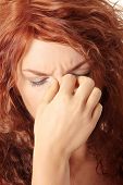stock photo of pressure  - Young woman with sinus pressure pain - JPG 