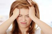 foto of woman  - Teen woman with headache holding her hand to the head - JPG 