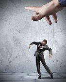 image of leadership  - Businessman marionette on ropes controlled by puppeteer - JPG 