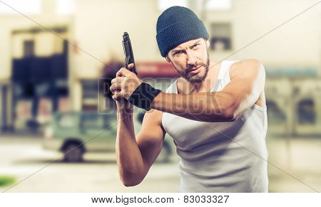 Poster: Handsome Criminal Holding A Gun