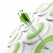 foto of business concept  - many green targets and three arrows reaching the center of objective image fading from green to white with blur effect square format - JPG 