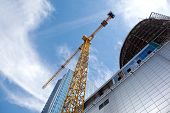 pic of construction  - Modern building under construction against blue sky - JPG 