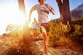 pic of fitness  - Trail running marathon athlete outdoors sunrise couple training for fitness and healthy lifestyle - JPG 