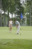 foto of golf  - Couple playing golf on golfing course - JPG 