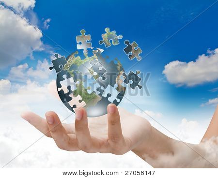 Picture or Photo of Business concept with a hand building puzzle globe
