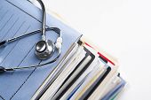 stock photo of medical  - Medical record concept with stetoschope over pile of document - JPG 