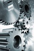 stock photo of industrial  - large industrial gears set against titanium and in a blue metallic toning concept - JPG 