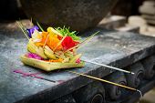 stock photo of religion  - Traditional balinese offerings to gods in Bali with flowers and aromatic sticks - JPG 