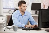 picture of computer  - Casual businessman working in office - JPG 