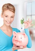 stock photo of money  - picture of lovely woman with piggy bank and money - JPG 
