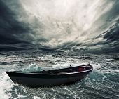 foto of boat  - Abandoned boat in stormy sea - JPG 