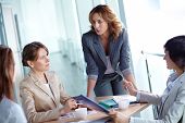 image of meeting  - Image of four businesswomen discussing business plan at meeting - JPG 