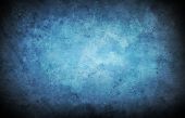 stock photo of blue  - A vignetted blue texture background with stains and scratches - JPG 