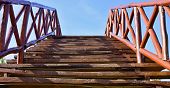stock photo of bridge  - The bridge for pedestrians is made of wooden boards and bars - JPG 
