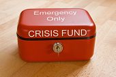 pic of investment  - Closed red cash tin marked Crisis Fund  - JPG 