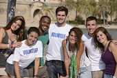 stock photo of diversity  - happy and diverse volunteer group smiling outdoors - JPG 