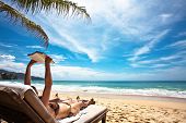 image of beach  - Relaxing and reading on the beach - JPG 