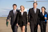 pic of leadership  - Group of four leaders smiling on the background of the airplane - JPG 