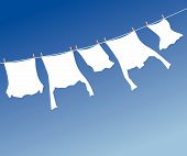 stock photo of blue sky  - White laundry hanging to dry on a clothes - JPG 