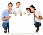 foto of holding  - Family holding a banner and smiling  - JPG 