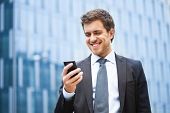 pic of businessmen  - Handsome businessman using a smartphone - JPG 