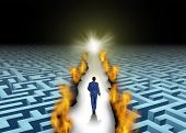 picture of leadership  - Innovative leadership and trail blazing or trailblazing business concept with a businessman walking through a maze or labyrinth that is open due to a burning path as a symbol of creative solutions - JPG 
