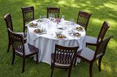 pic of setting  - Table setting with chairs for garden banquet - JPG 