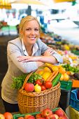 picture of food  - a young woman buying fruits and vegetables at a market - JPG 