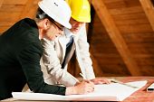 stock photo of construction  - Architect and construction engineer or surveyor discussion plans and blueprints - JPG 