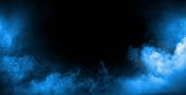 Dark background full of dense, white smoke