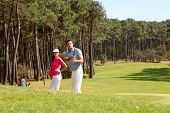 stock photo of golf  - Couple playing golf on a sunny day - JPG 