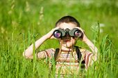 foto of watch  - Young boy in a field looking through binoculars - JPG 