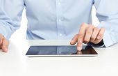 stock photo of businessmen  - Close up of young businessman using digital tablet - JPG 