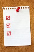 stock photo of tickbox  - Torn page from spiral notebook on corkboard - JPG 