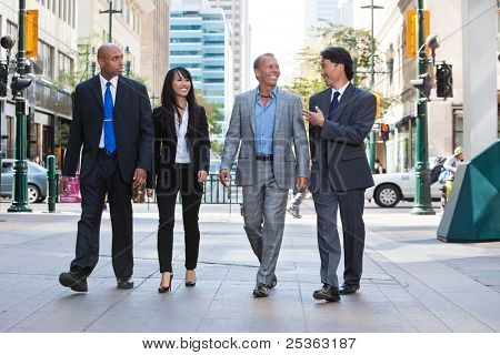 Picture or Photo of Group of happy business people walking together on street