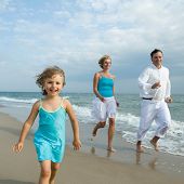 foto of beach  - Happy family playing at the beach - JPG 