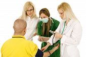 stock photo of bloodpressure  - medical team with female doctors measuring bloodpressure isolated over white background - JPG 