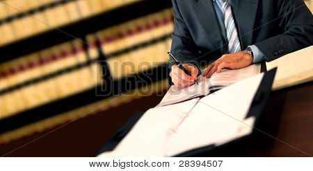 Picture or Photo of Lawyer working at his desk in the office