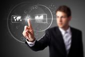 picture of future  - Businessman pressing high tech type of modern buttons on a virtual background - JPG 