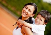 pic of young adult  - Lovely portrait of a mother and son at the tennis court - JPG 