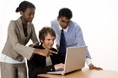 picture of computer technology  - three people working on a silver laptop computer - JPG 