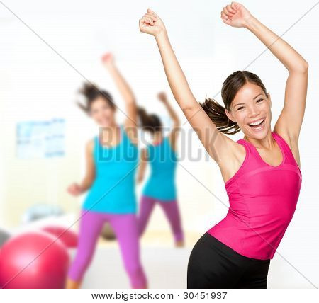 Picture or Photo of Fitness dance class aerobics. Women dancing happy energetic in gym fitness class. (note to editor: 1 model as composite)