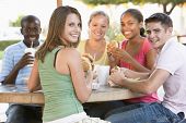 picture of food  - Group Of Teenagers Sitting Outdoors Eating Fast Food - JPG 