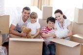 picture of family  - Happy young family Moving Home With Boxes Around - JPG 