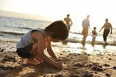 picture of time  - Kid on beach in sand playing - JPG 