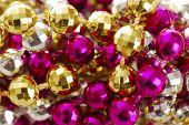 stock photo of blue sky  - background of colorful mardi gras beads including gold silver and pink - JPG 