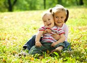 stock photo of play  - Cute children are playing in autumn park - JPG 