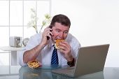 pic of food  - man at office with phone eat unhealthy fast food - JPG 